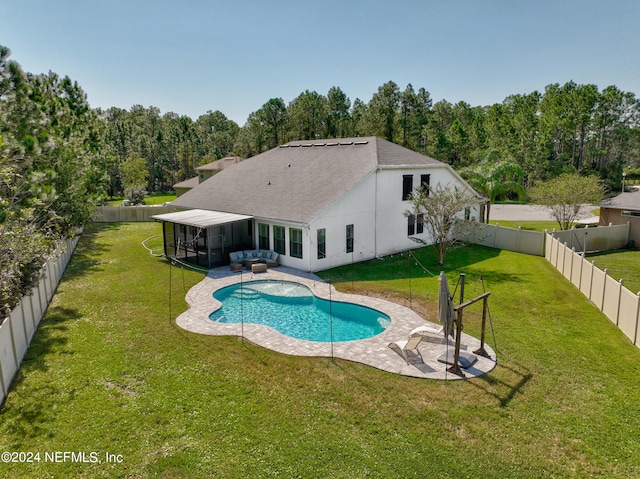 view of pool featuring a sunroom, a patio area, and a yard