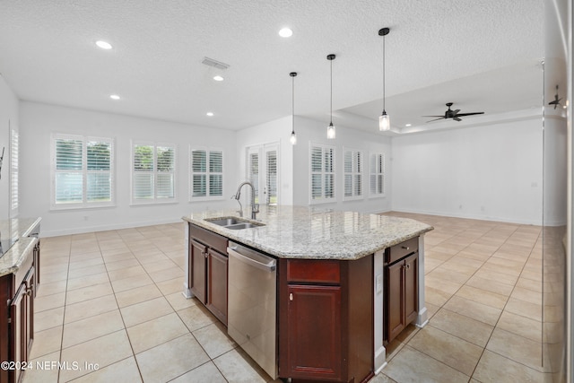 kitchen featuring ceiling fan, dishwasher, sink, an island with sink, and decorative light fixtures