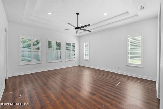 unfurnished room featuring dark hardwood / wood-style floors, ceiling fan, and a textured ceiling