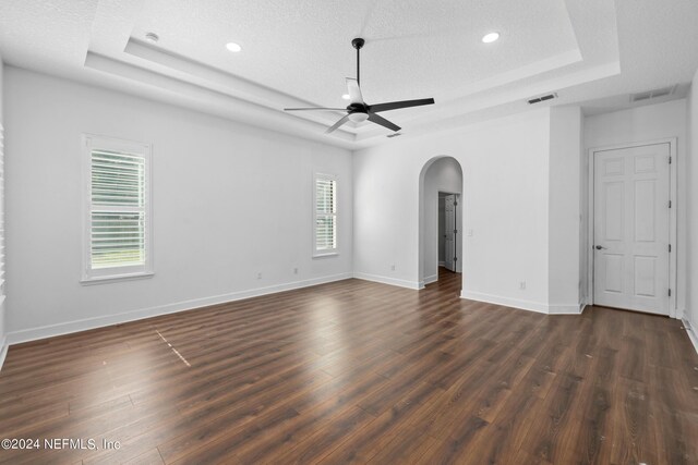 1309 Acorn Ridge Ct, Saint Augustine, FL 32092 - unfurnished room featuring visible vents, a ceiling fan, dark wood-style floors, a raised ceiling, and arched walkways