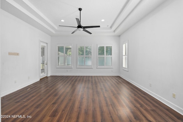1309 Acorn Ridge Ct, Saint Augustine, FL 32092 - spare room featuring baseboards, dark wood-style flooring, ceiling fan, and a tray ceiling