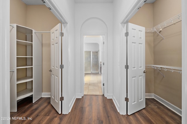 corridor with dark hardwood / wood-style flooring