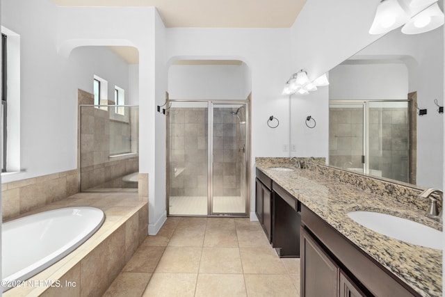 bathroom with tile patterned floors, vanity, and independent shower and bath