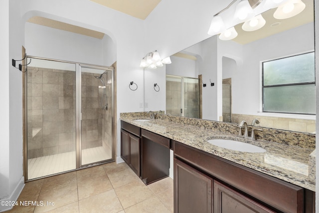 bathroom featuring tile patterned floors, vanity, and an enclosed shower