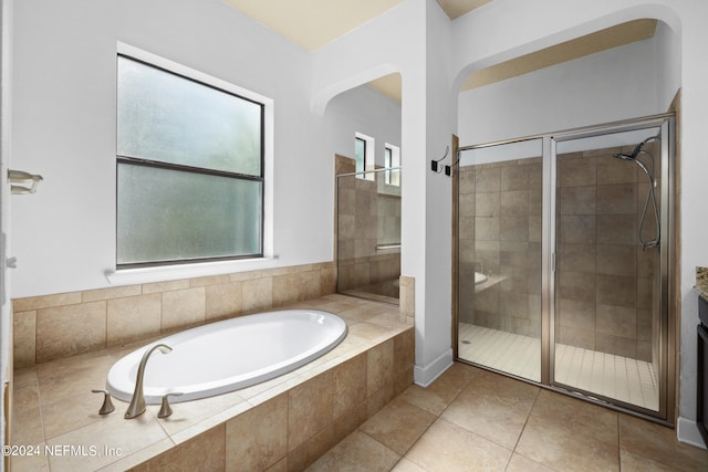 bathroom with shower with separate bathtub and tile patterned floors