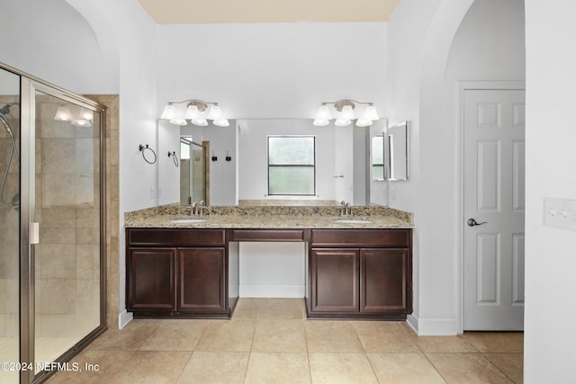 bathroom featuring vanity, tile patterned floors, and a shower with shower door