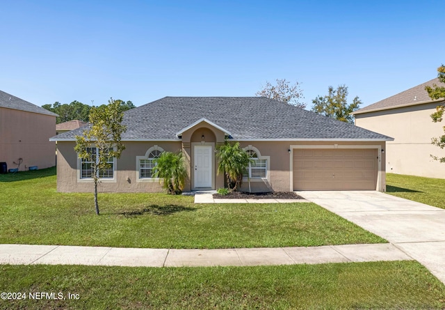 ranch-style house featuring a front lawn and a garage