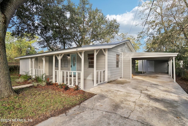 view of front of property with covered porch and a carport