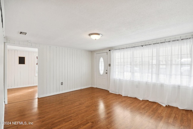 interior space with wood-type flooring and a textured ceiling