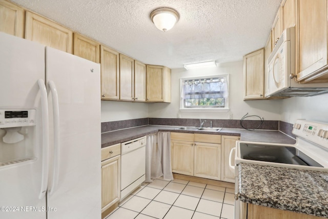 kitchen featuring a textured ceiling, sink, light tile patterned flooring, light brown cabinetry, and white appliances