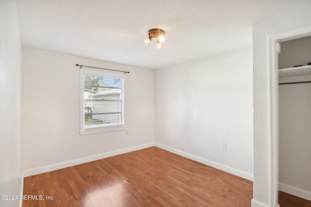 unfurnished bedroom with hardwood / wood-style flooring