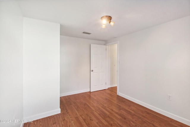 spare room with wood-type flooring