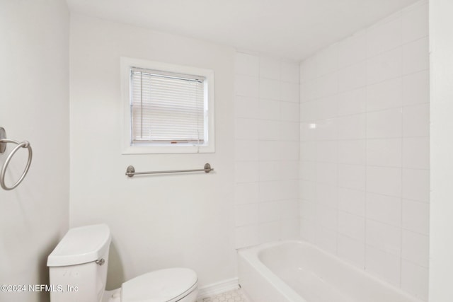 bathroom featuring toilet and tiled shower / bath combo