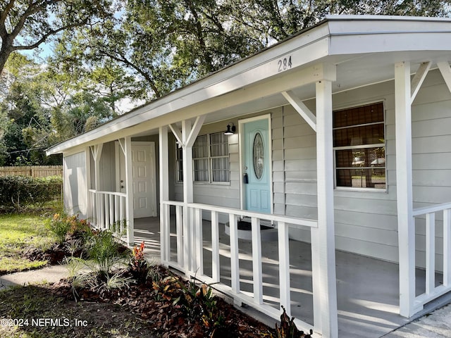 property entrance featuring covered porch