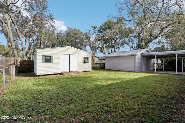 view of yard with a storage shed and a carport