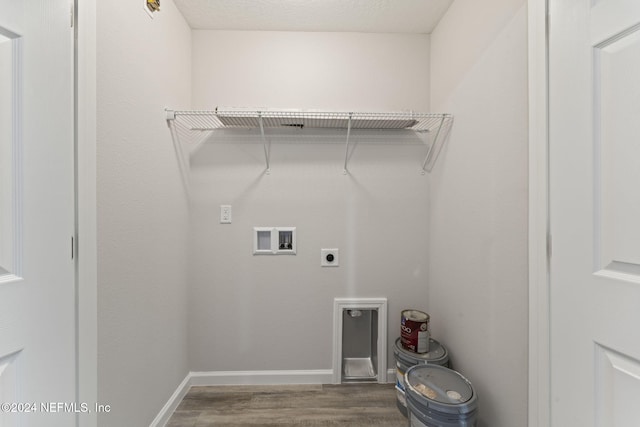 laundry room with hookup for an electric dryer, a textured ceiling, hardwood / wood-style flooring, and washer hookup