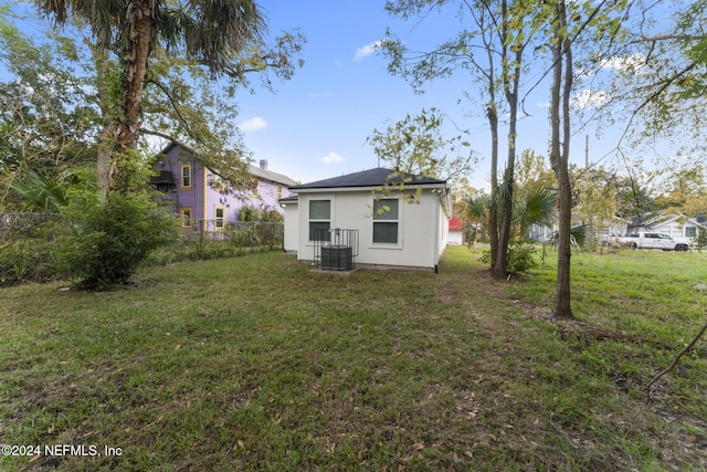 rear view of property with a lawn