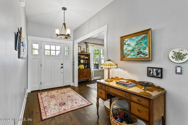 entryway featuring a chandelier and dark hardwood / wood-style flooring