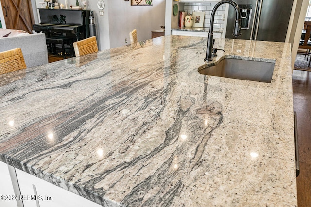 kitchen with sink and light stone counters