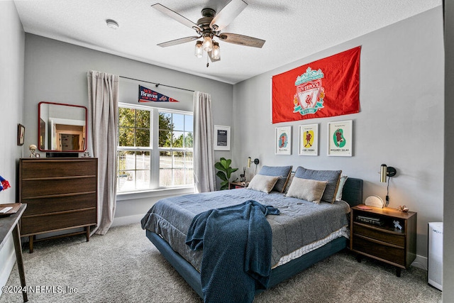 carpeted bedroom with a textured ceiling and ceiling fan