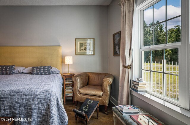 bedroom with dark wood-type flooring