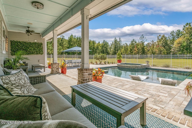 view of patio featuring outdoor lounge area, a swimming pool with hot tub, and ceiling fan