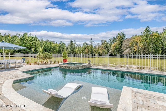 view of swimming pool with a patio, an in ground hot tub, and a lawn