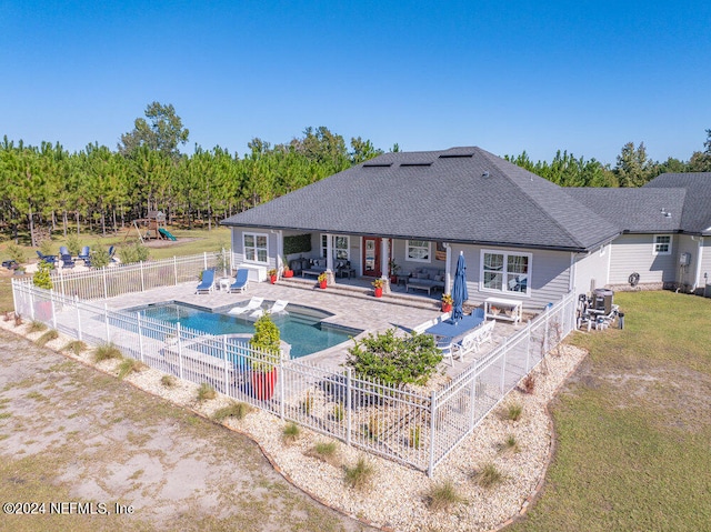 view of pool with a patio and a yard