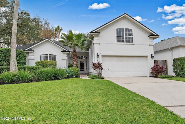 view of front of property with a front yard and a garage