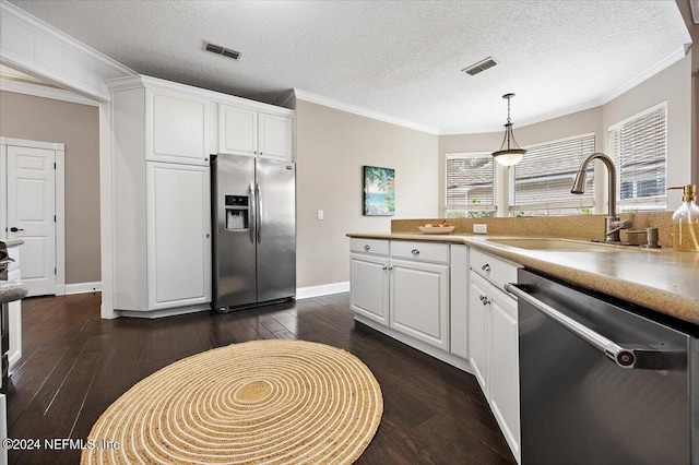 kitchen with dark wood-type flooring, stainless steel appliances, sink, white cabinets, and a textured ceiling