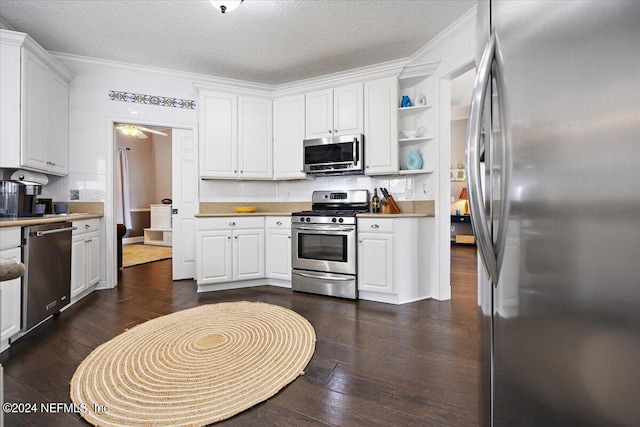 kitchen featuring stainless steel appliances, dark hardwood / wood-style flooring, and white cabinets