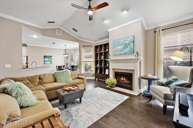 living room with crown molding, a textured ceiling, vaulted ceiling, and dark hardwood / wood-style floors