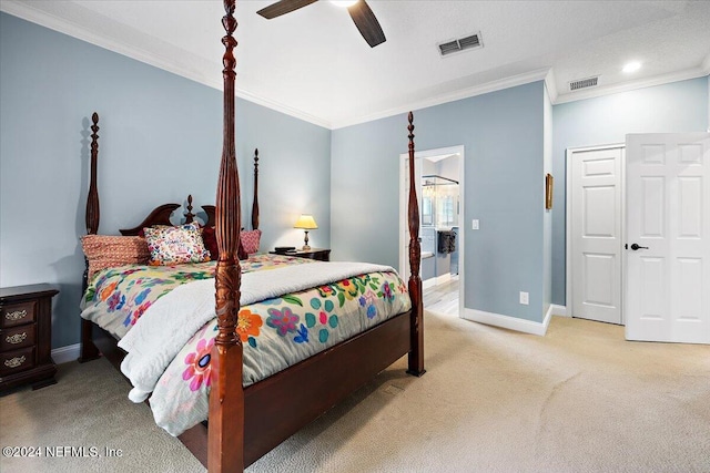 carpeted bedroom featuring a closet, ceiling fan, ornamental molding, and ensuite bathroom