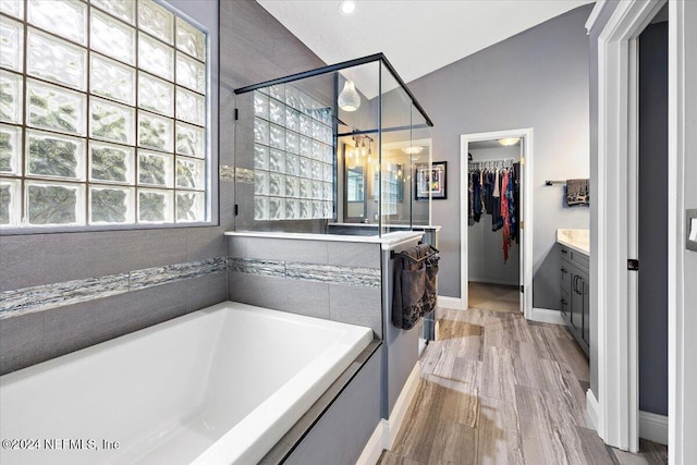 bathroom with vanity, hardwood / wood-style flooring, and independent shower and bath