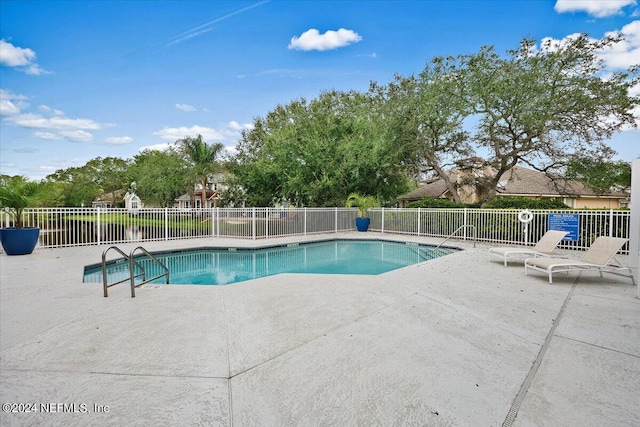 view of swimming pool with a patio area