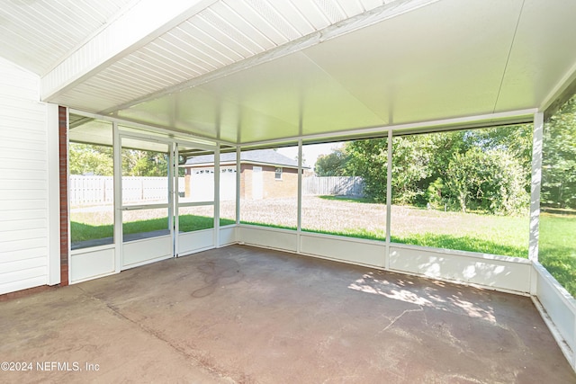 unfurnished sunroom with vaulted ceiling