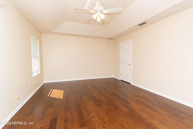 empty room with ceiling fan, a textured ceiling, and dark hardwood / wood-style floors