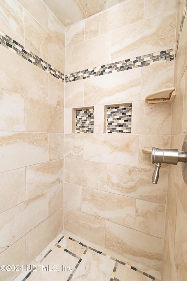 bathroom with tiled shower