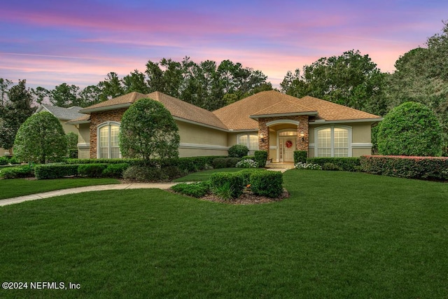 mediterranean / spanish-style home with a yard