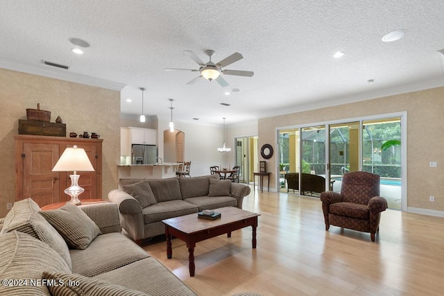 living room featuring crown molding, a textured ceiling, light hardwood / wood-style flooring, and ceiling fan with notable chandelier