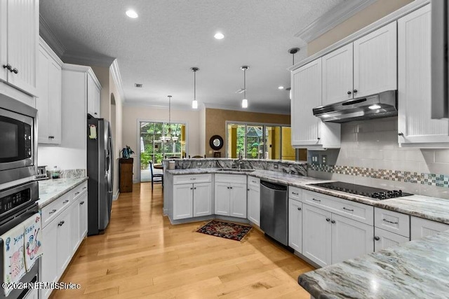 kitchen with hanging light fixtures, kitchen peninsula, stainless steel appliances, light wood-type flooring, and white cabinets