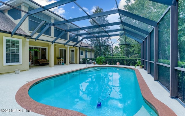 view of pool featuring a patio area and a lanai