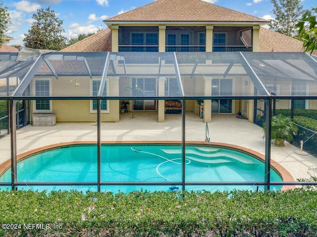 view of pool with a patio and a lanai