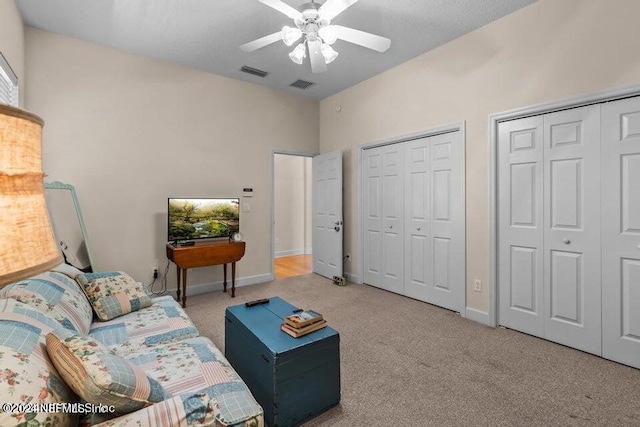 living area with light colored carpet and ceiling fan