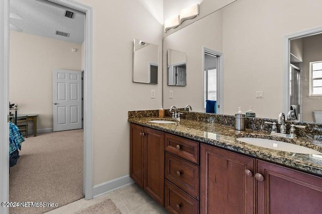 bathroom with vanity, tile patterned floors, and walk in shower