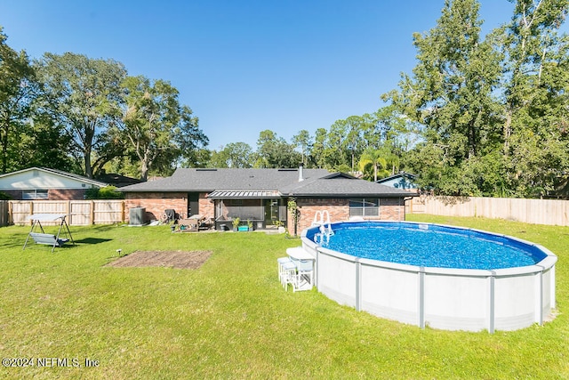 view of pool with a patio area and a lawn