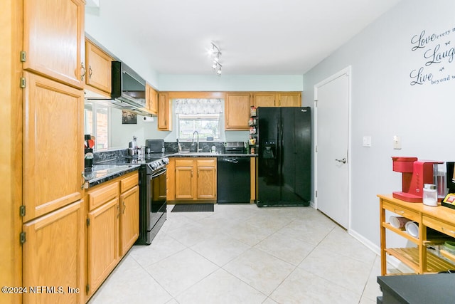 kitchen with light tile patterned floors, black appliances, sink, and ventilation hood