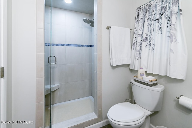 bathroom featuring toilet and an enclosed shower