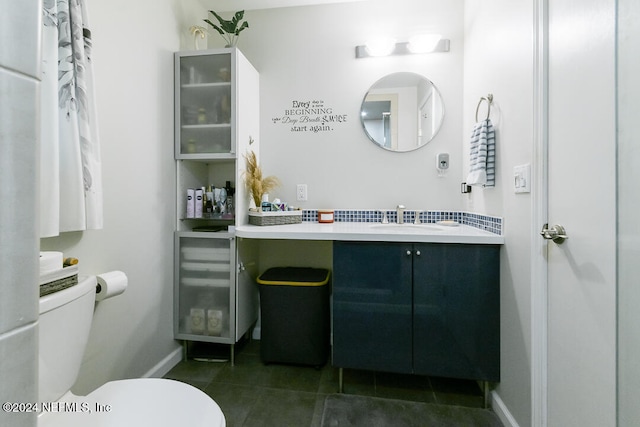 bathroom with vanity, toilet, and tile patterned floors