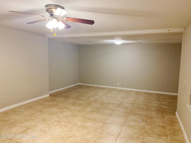 spare room with a textured ceiling and ceiling fan